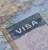 A visa page with an entry stamp, on a map